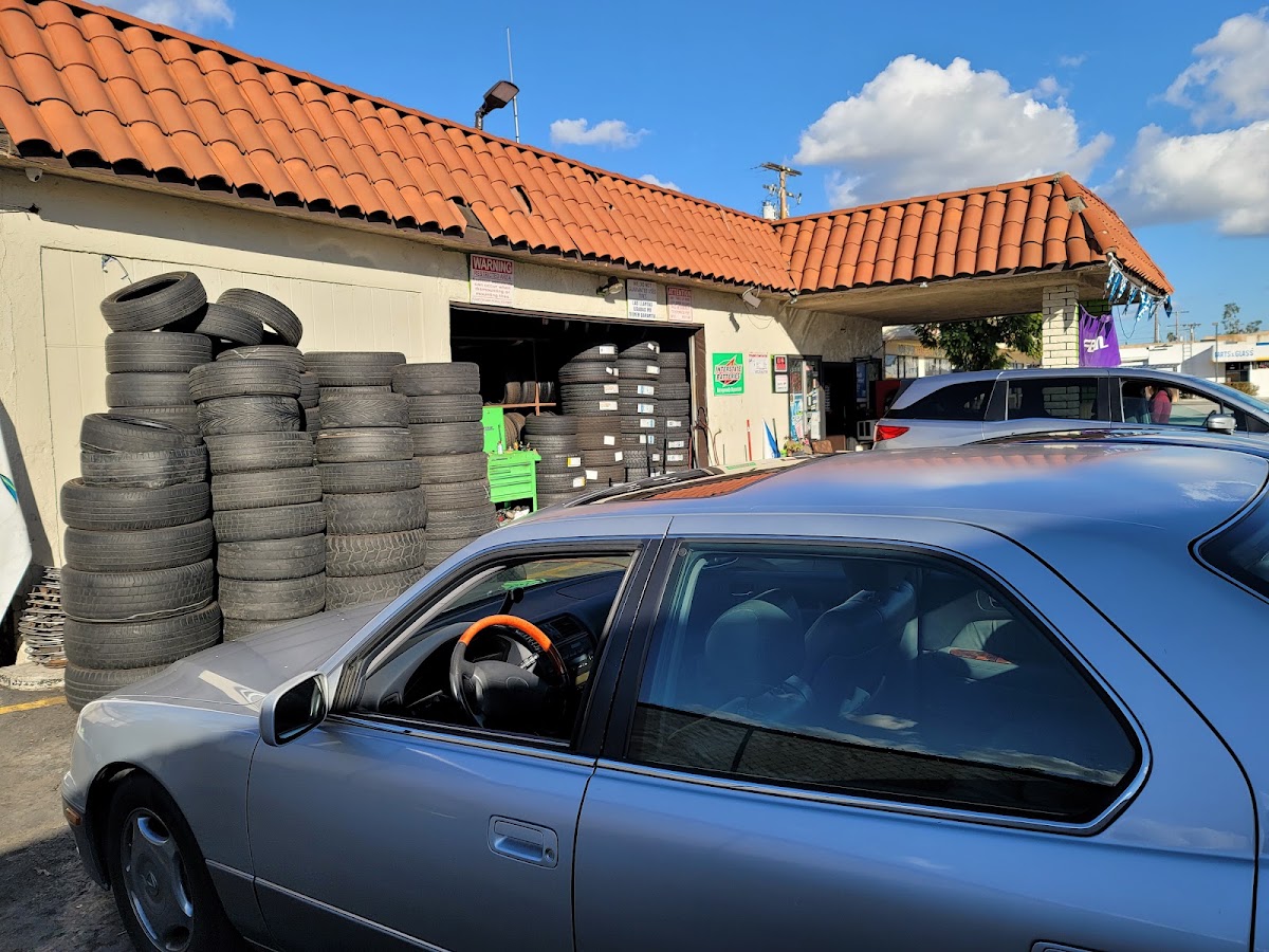 Fast Tire Service shop in Cypress with tires stacked outside